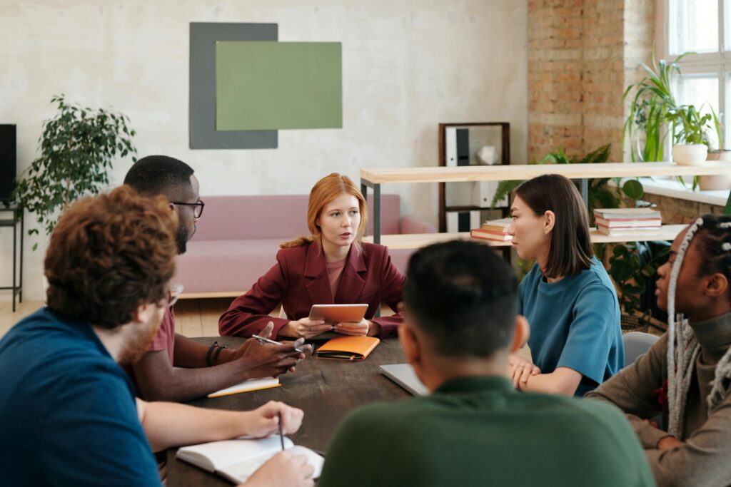 people working on a project around a conference room table